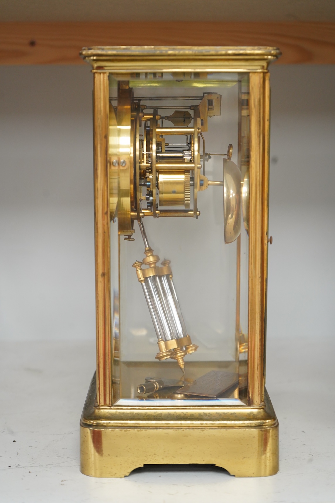 An early 20th century French brass and four glass mantel clock, striking on bell, with pendulum and key, 29cm high